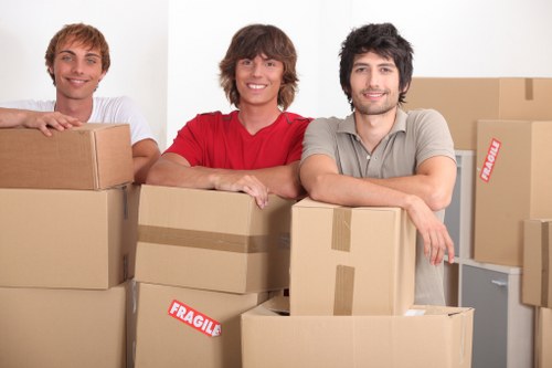 Professional movers handling IT and furniture during an office move