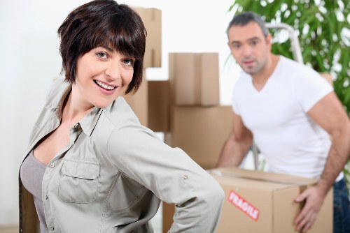 Trained movers protecting items while carrying them through a property